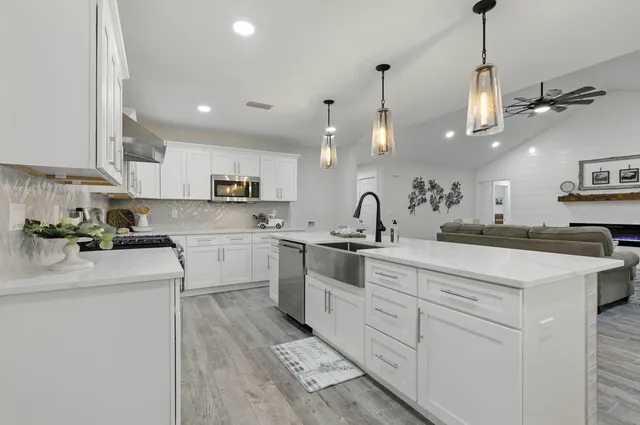 a bedroom with a large bed and a chandelier