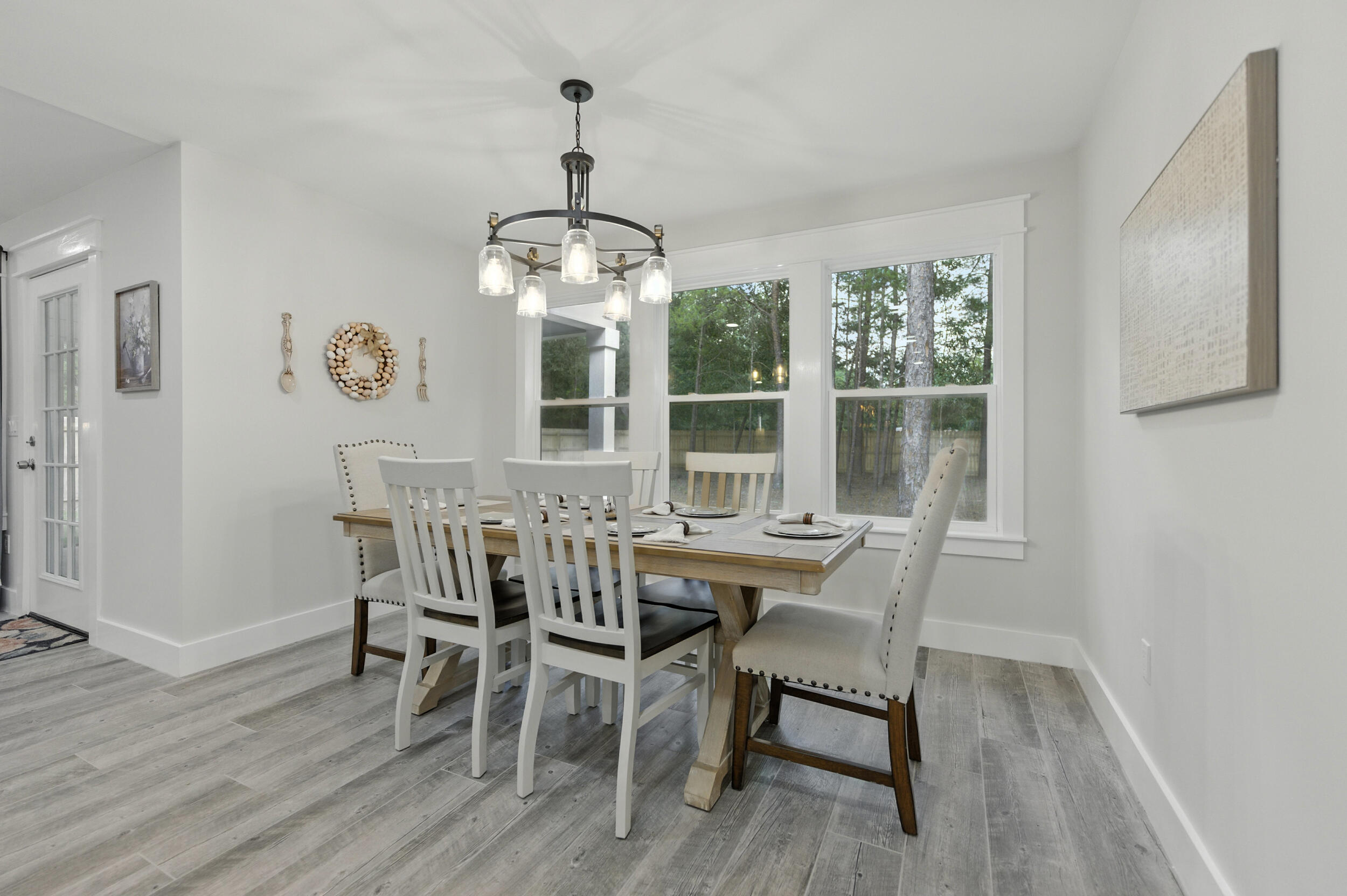 172 Frazier Road DeFuniak Springs, FL 32433 - Photo 28 of 78 a view of a dining room with furniture wooden floor and chandelier