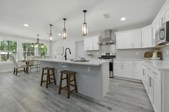 a bathroom with a granite countertop toilet and a sink