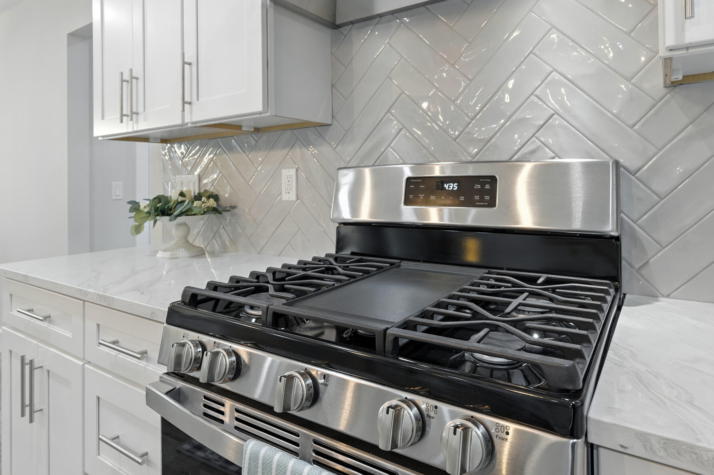 172 Frazier Road DeFuniak Springs, FL 32433 - Photo 32 of 78 a stove sitting inside of a kitchen with white cabinets