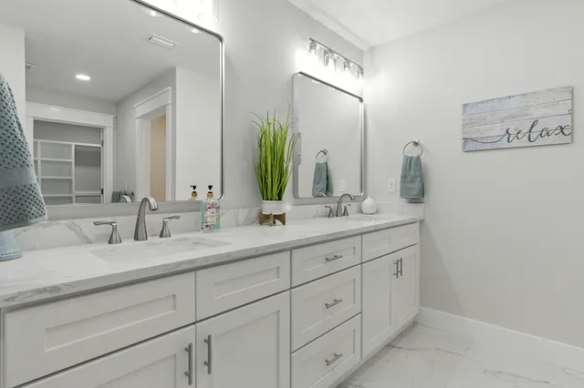 a spacious bedroom with a bed and a chandelier