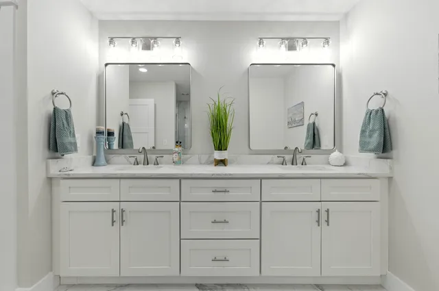 a view of a bedroom with a bed and a chandelier