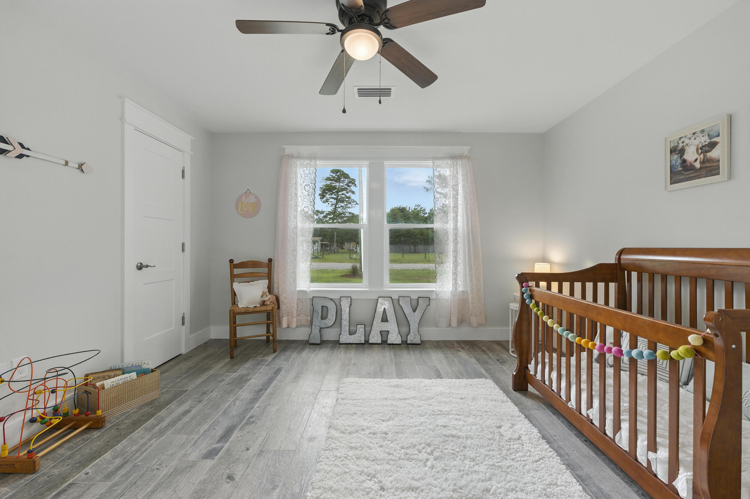 172 Frazier Road DeFuniak Springs, FL 32433 - Photo 53 of 78 a living room with a baby crib furniture and a window