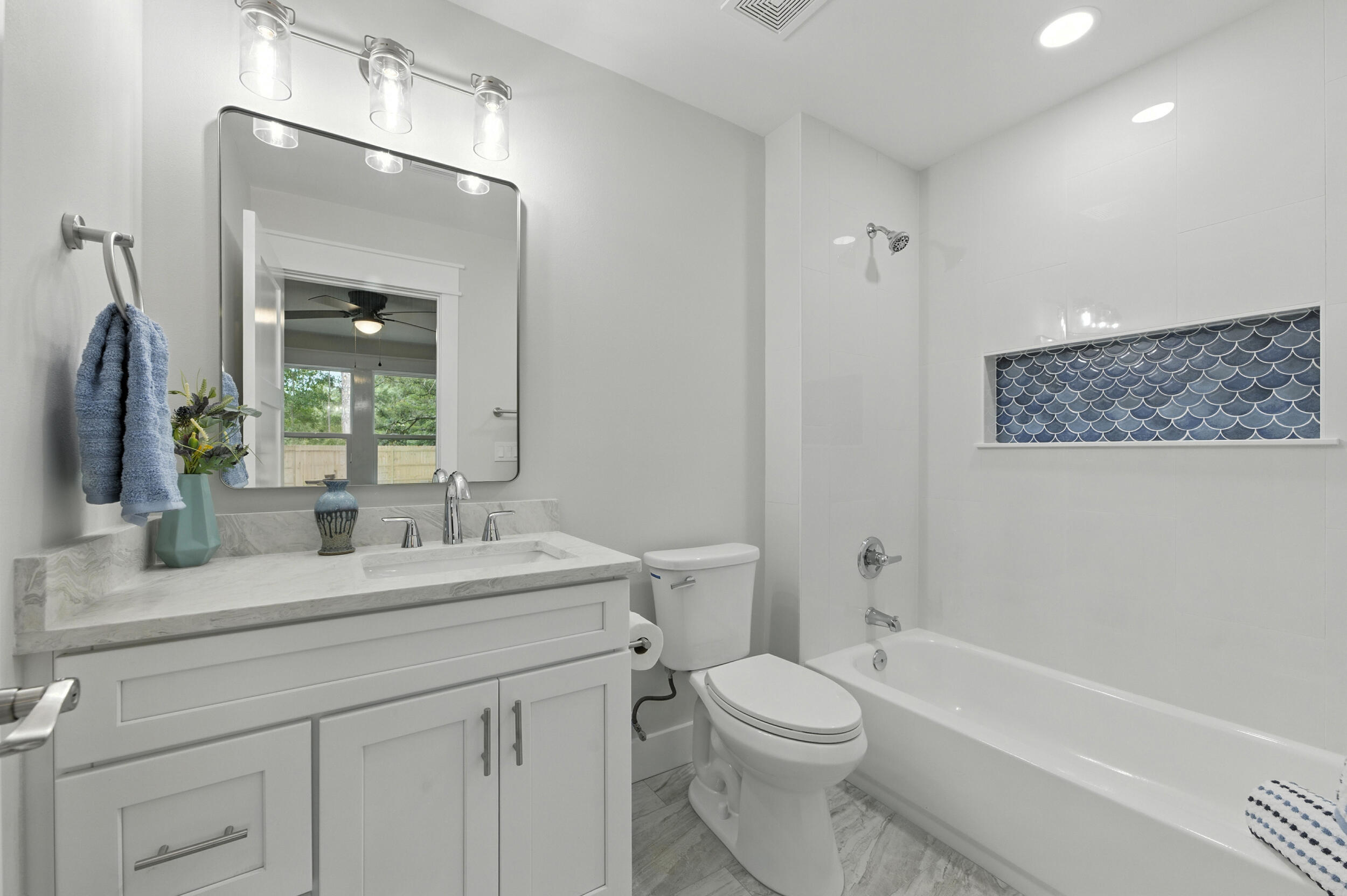 172 Frazier Road DeFuniak Springs, FL 32433 - Photo 60 of 78 a bathroom with a toilet a sink a tub and mirror
