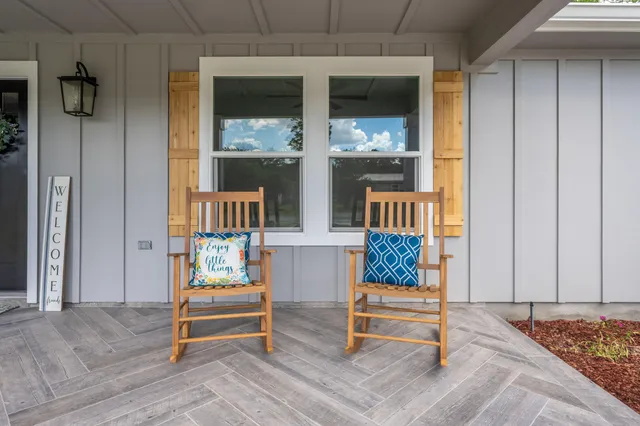 a view of a workspace room with wooden floor table and staircase