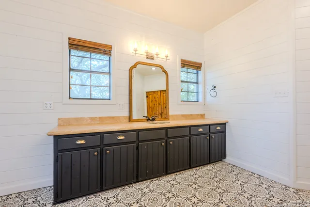 a bathroom with a sink and a mirror