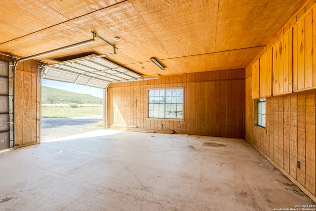 a view of back yard with swimming pool and seating