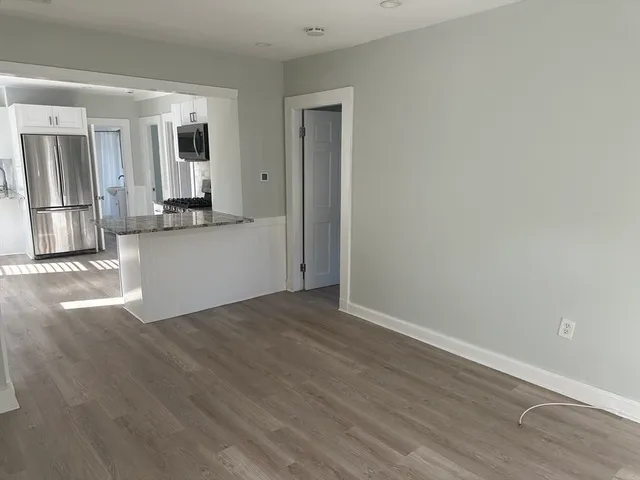 a view of a kitchen with wooden floor and a sink