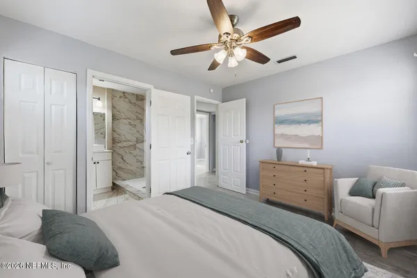 a bedroom with a bed and a couch