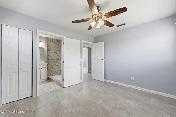 an empty room with chandelier fan
