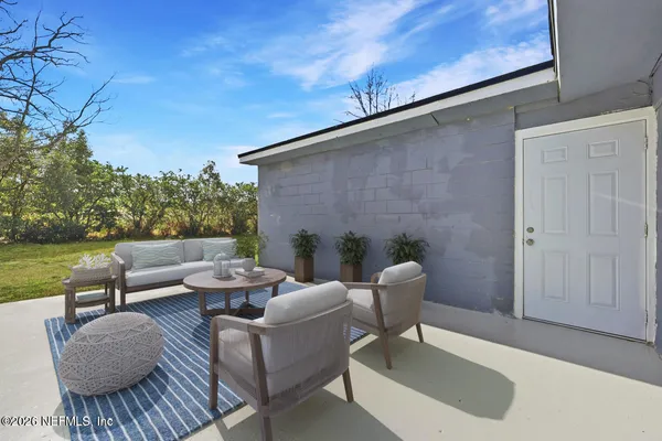 a balcony with furniture and a potted plant