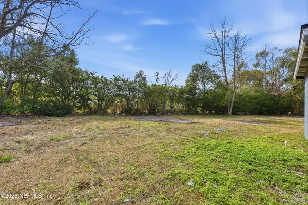 a view of a field with trees