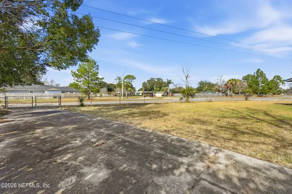 a view of a big yard with palm trees