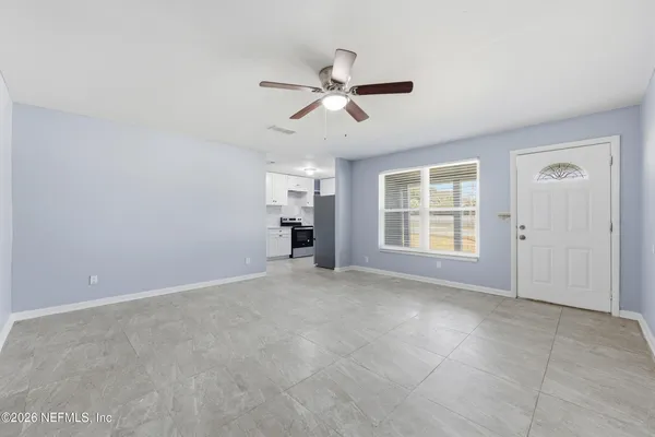 a view of an empty room with a window