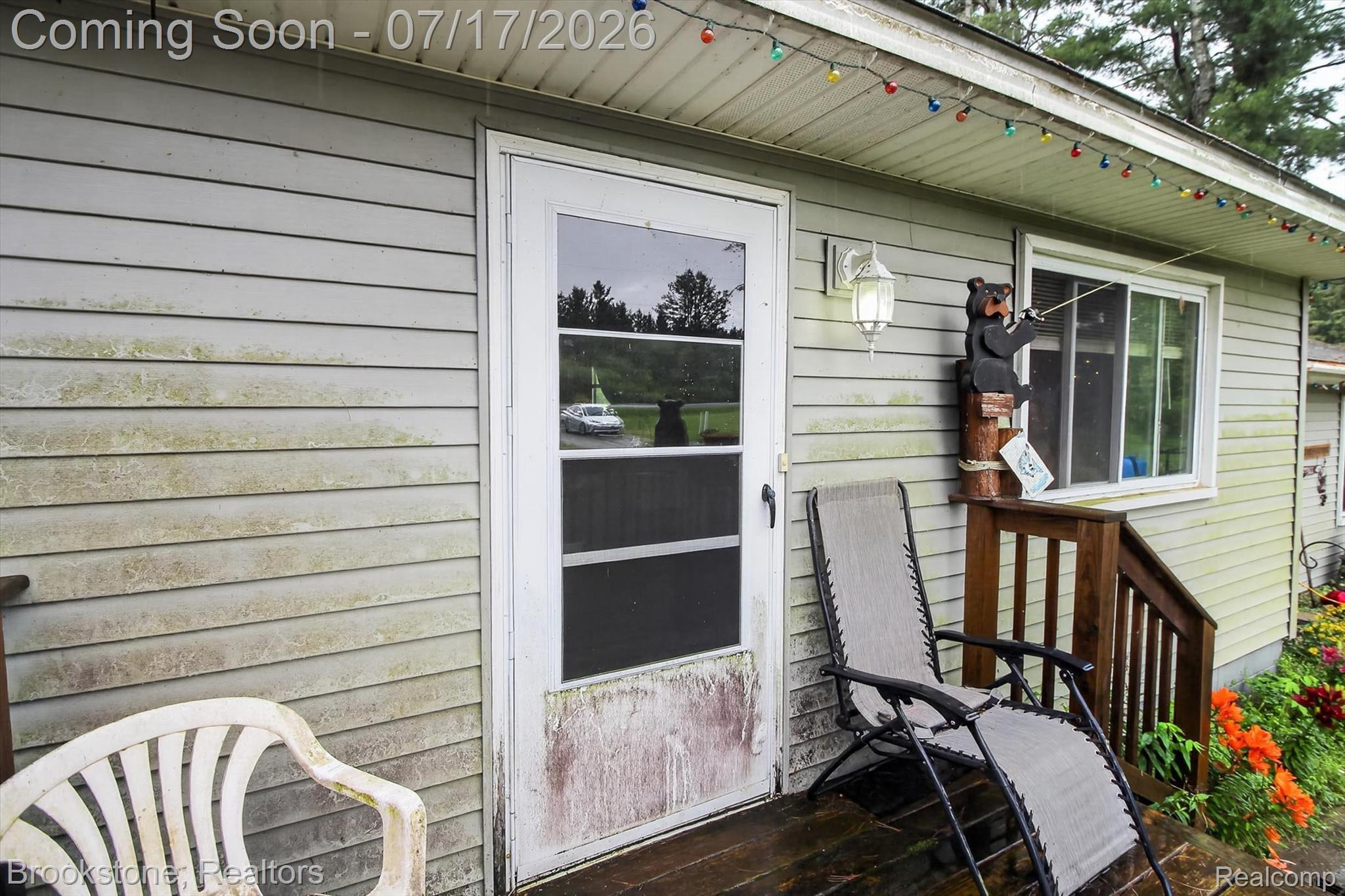 22709 Pleasant Valley Road Hillman, MI 49746 - Photo 8 of 42 Exterior siding featuring a full-light storm door and a window