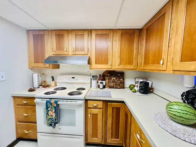 a kitchen with stainless steel appliances granite countertop a sink stove and cabinets