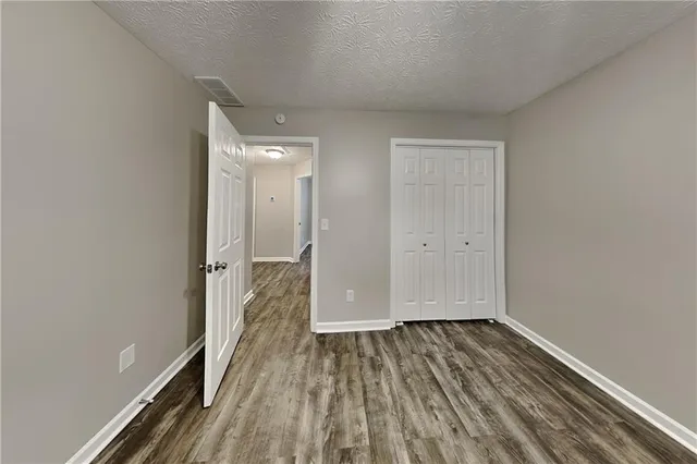 a view of a room with wooden floor and a gate