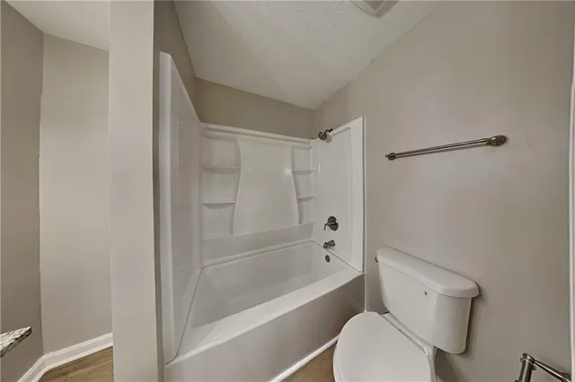 a bathroom with a toilet and a bathtub