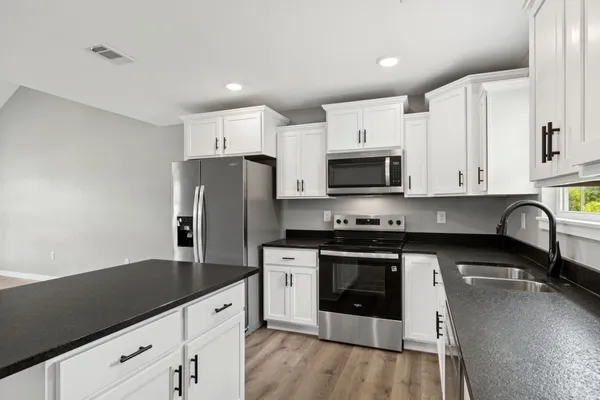 a view of a kitchen with microwave and stove