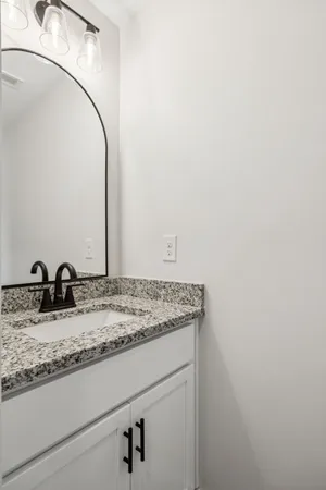 a bathroom with a double vanity sink and mirror