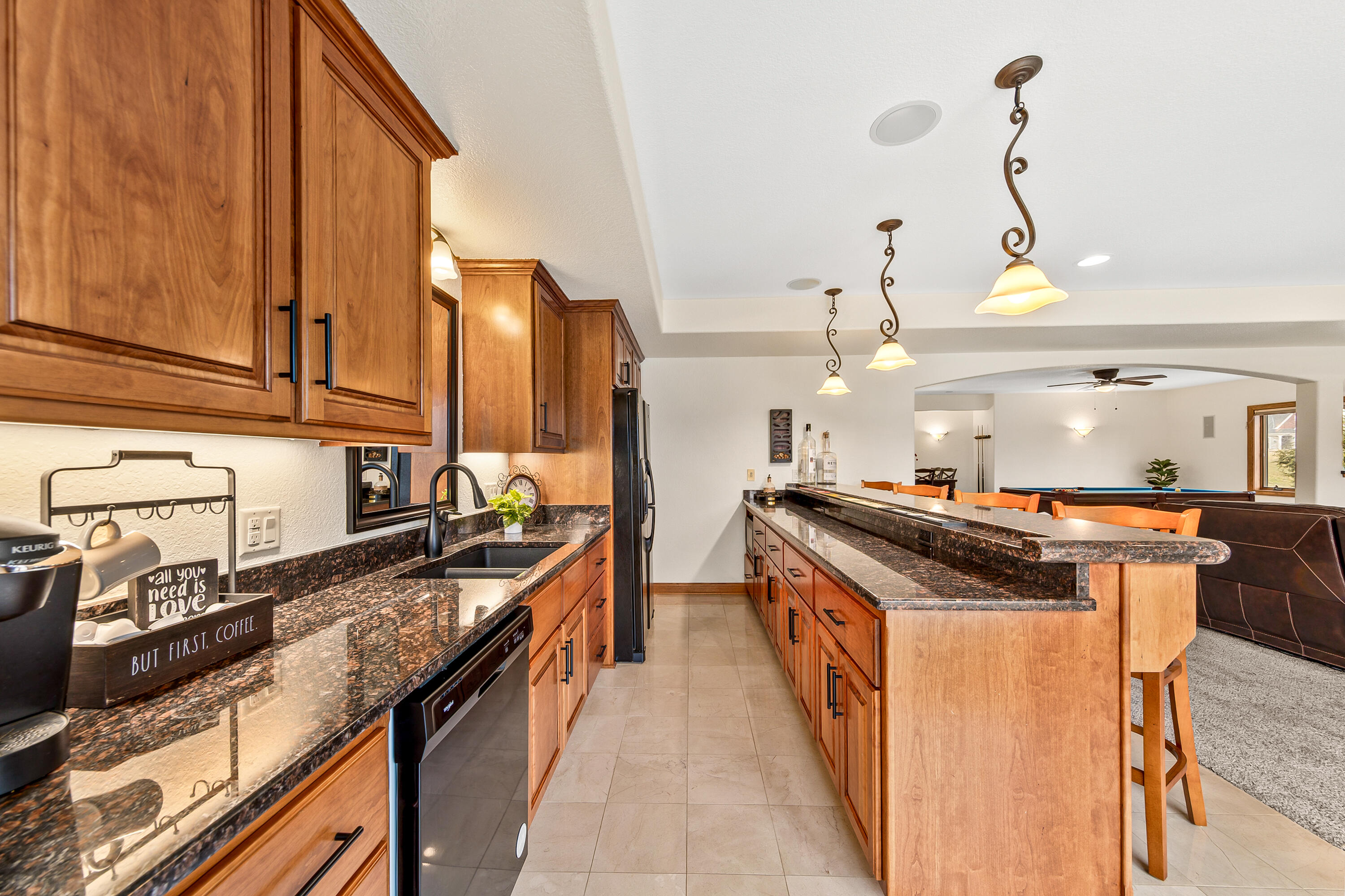 S62W28195 Ridge Valley Road Genesee, WI 53189 - Photo 41 of 68 Luxury wet bar with custom cherry cabinetry, dishwasher, sink, microwave & full-size fridge/freezer plus granite countertops.