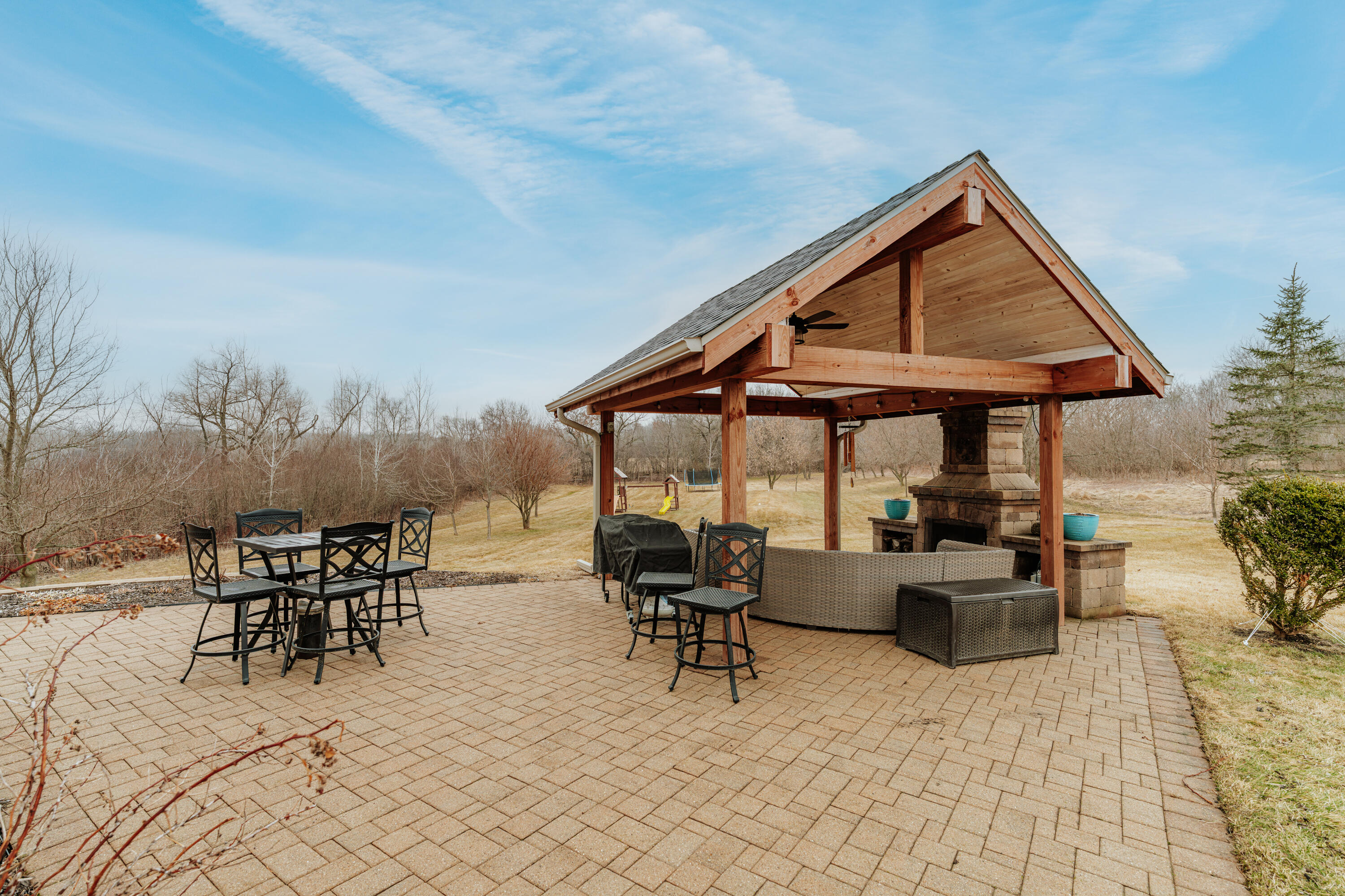 S62W28195 Ridge Valley Road Genesee, WI 53189 - Photo 59 of 68 Prime outdoor entertaining space with electrical & brick fireplace to enjoy your summer nights.