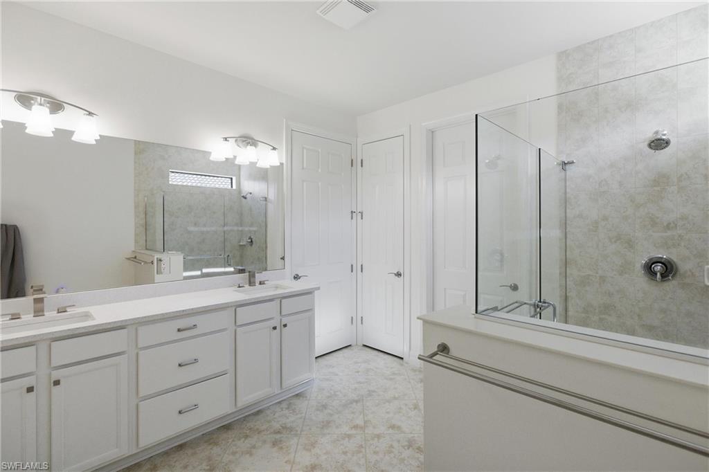 11041 Castlereagh Street Fort Myers, FL 33913 - Photo 13 of 49 a bathroom with a double vanity sink and mirror with shower
