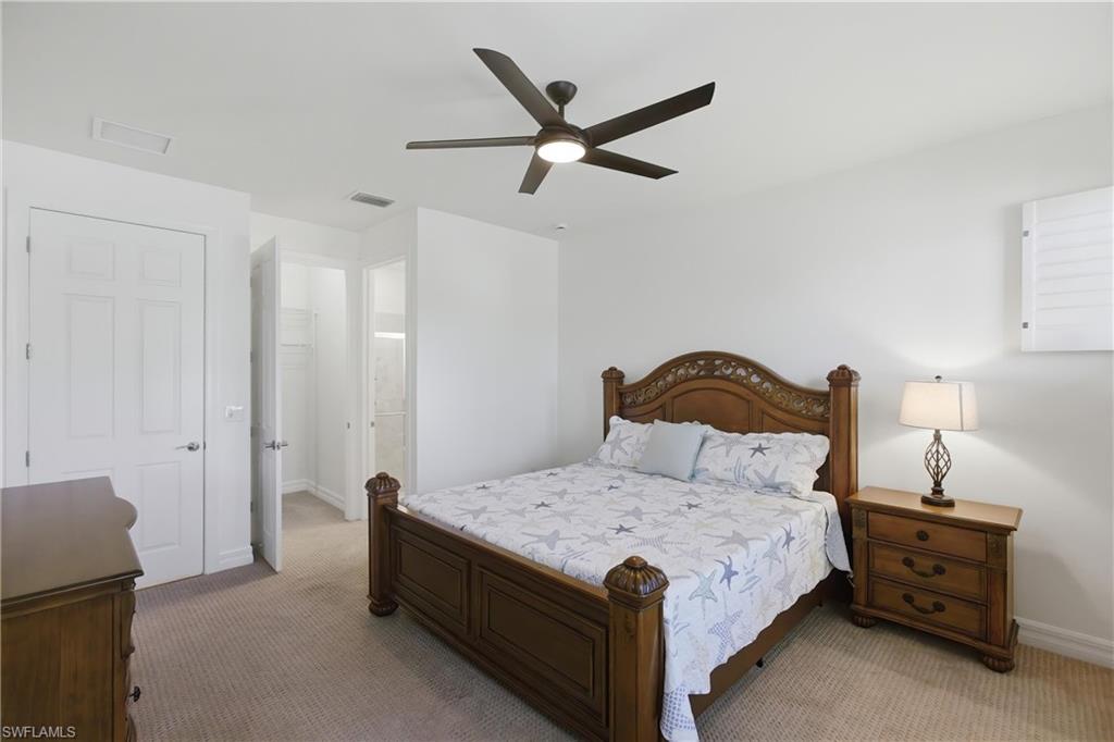 11041 Castlereagh Street Fort Myers, FL 33913 - Photo 17 of 49 a bedroom with a bed and a ceiling fan