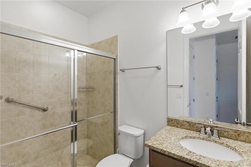 11041 Castlereagh Street Fort Myers, FL 33913 - Photo 19 of 49 a bathroom with a granite countertop sink toilet and shower
