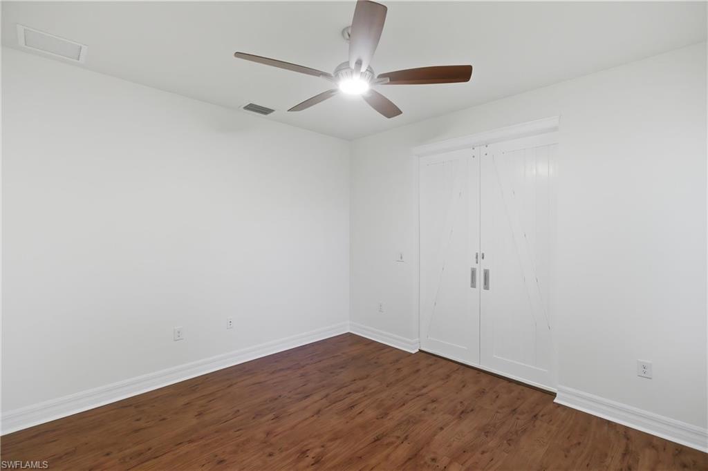 11041 Castlereagh Street Fort Myers, FL 33913 - Photo 24 of 49 a view of an empty room with wooden floor