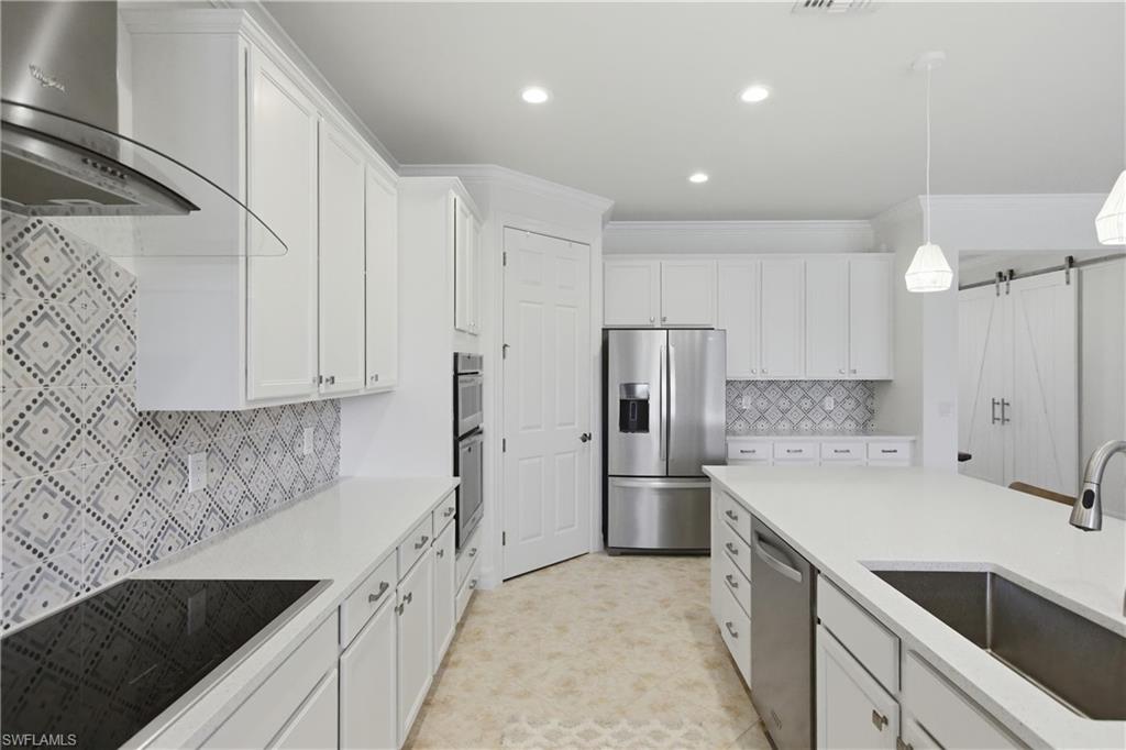 11041 Castlereagh Street Fort Myers, FL 33913 - Photo 4 of 49 a kitchen with a sink a refrigerator and a stove