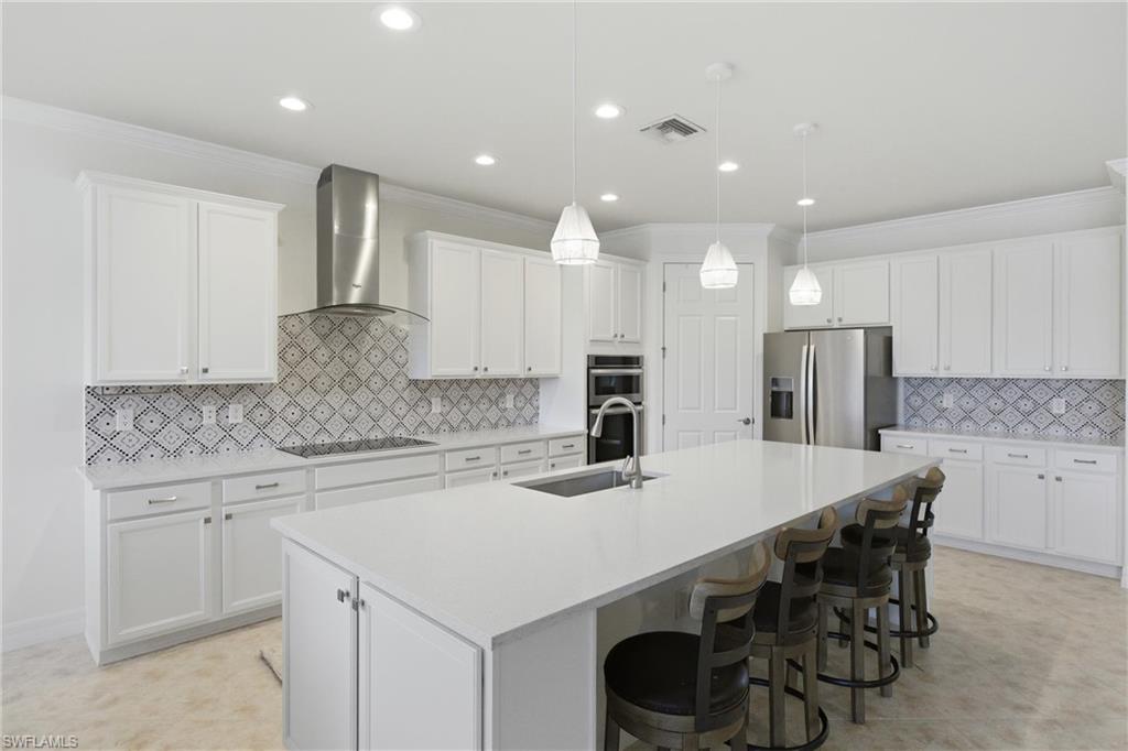11041 Castlereagh Street Fort Myers, FL 33913 - Photo 6 of 49 a kitchen with stainless steel appliances a sink and white cabinets