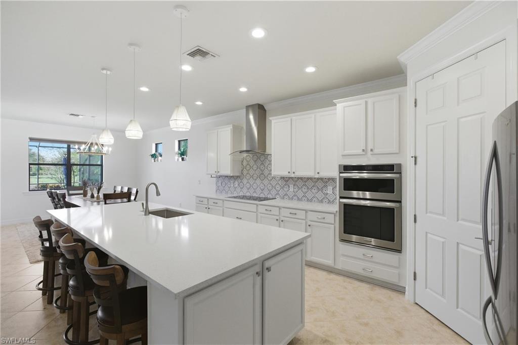 11041 Castlereagh Street Fort Myers, FL 33913 - Photo 7 of 49 a kitchen with kitchen island a sink stainless steel appliances and cabinets
