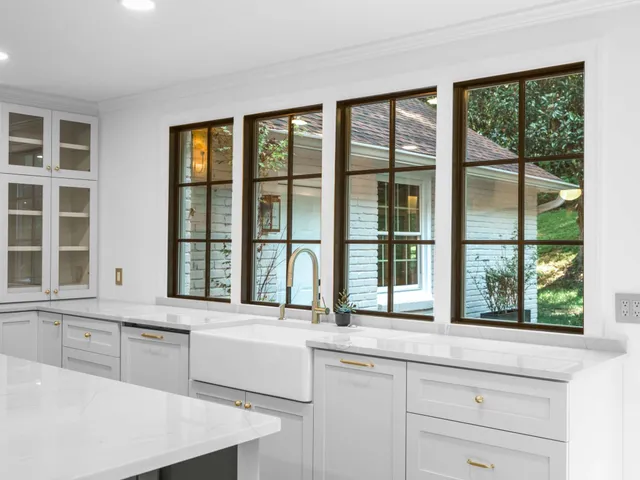 a view of an empty room with a fireplace and a window