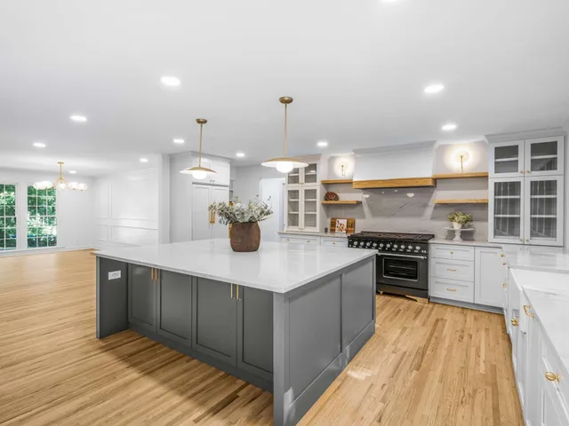 a bathroom with a tub a sink and a large mirror