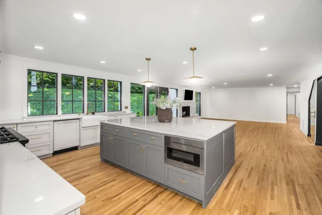a bathroom with a tub shower and window