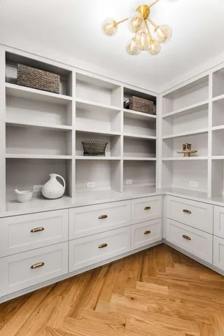 a bathroom with double vanity sink a two mirror a window and a bathtub
