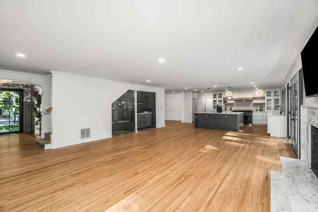 a spacious bedroom with a bed and a large window