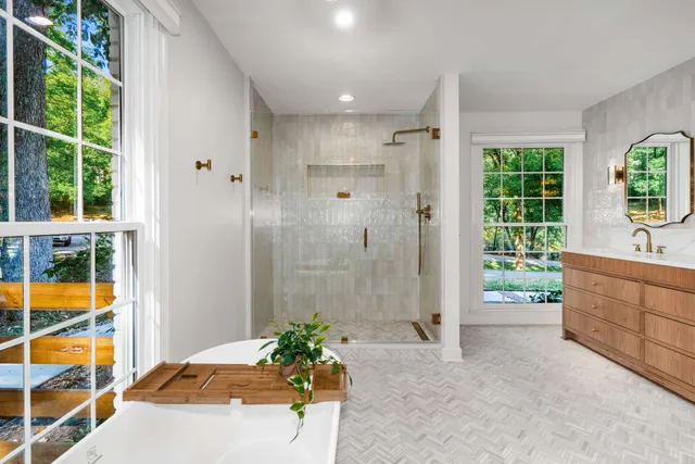 a view of a livingroom with a chandelier fan and wooden floor