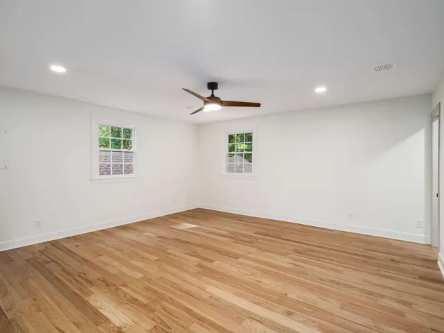 a front view of a house with a garden and plants