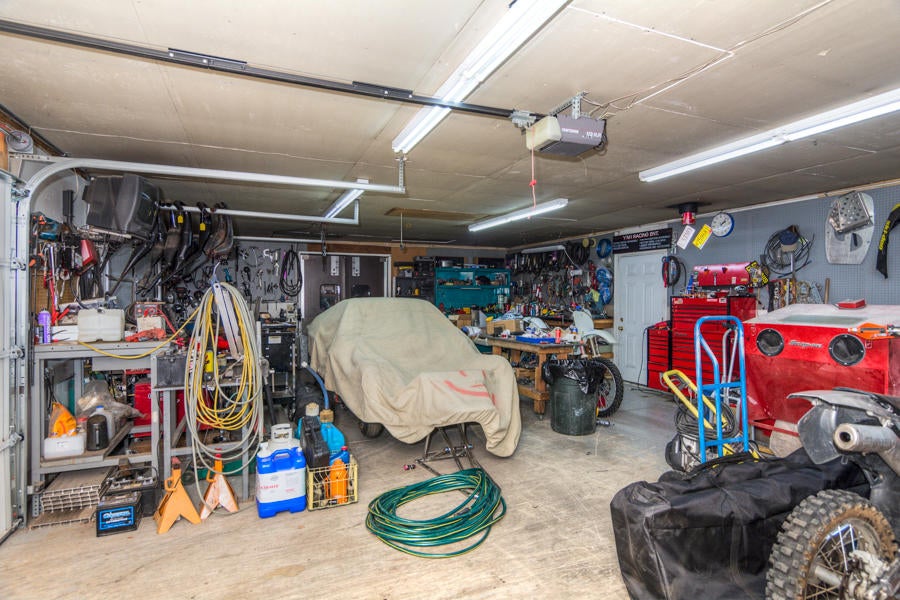 19116 Kiowa Road Bend, OR 97702 - Photo 34 of 38 Double car shop area 24 X 36, with additional 12 X 36 storage area through the door shown in the back of the photo.