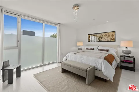 a spacious bedroom with a bed and a table