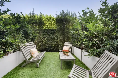 a view of a two chairs in the patio