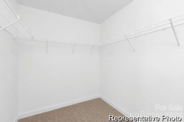 a view of a small space with wooden floor and a window