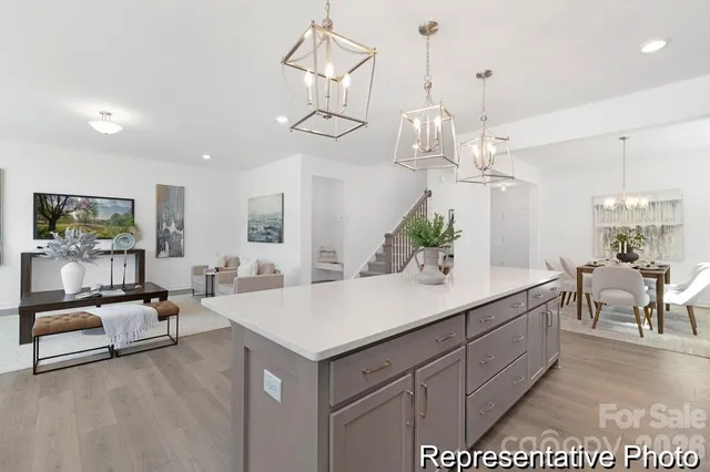 a view of a dining room with furniture and chandelier
