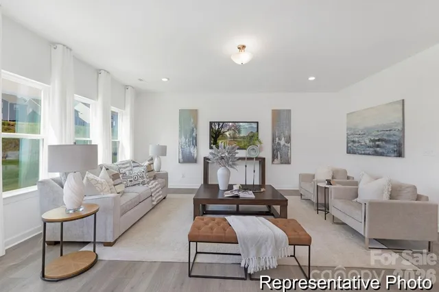 a living room with furniture dining table and kitchen view