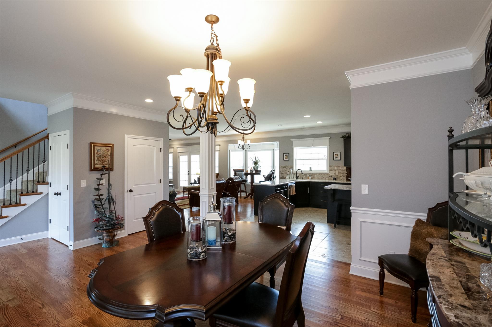 1069 Northern Road Mount Juliet, TN 37122 - Photo 4 of 30 a dining room with wooden floor a chandelier a wooden table and chairs