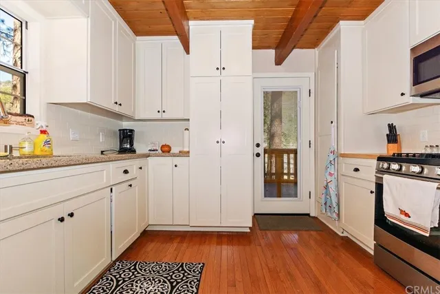 a kitchen with cabinets and appliances
