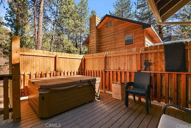 an outdoor sitting area with furniture and wooden floor