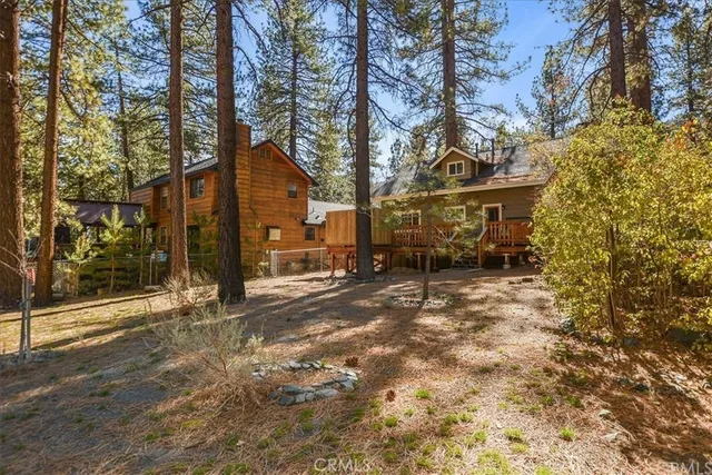 a view of a house with a yard covered in snow